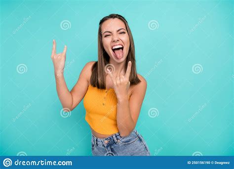Photo Of Cheerful Crazy Happy Young Woman Hold Rock Sign Face Stick Out Tongue Cool Isolated On