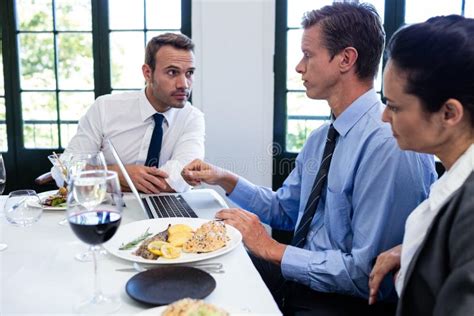 Businessmen Discussing During A Business Lunch Meeting Stock Photo