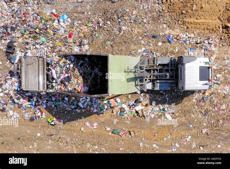 Loaded Garbage Trucks Unloading At A Municipal Landfill Top Down