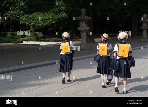 Three Japanese Middle School Girls Wearing Sailor Uniforms And Cute