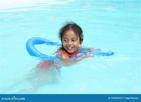 Happy Multiracial Ethnic Girl Child Learning To Swim Stock Image