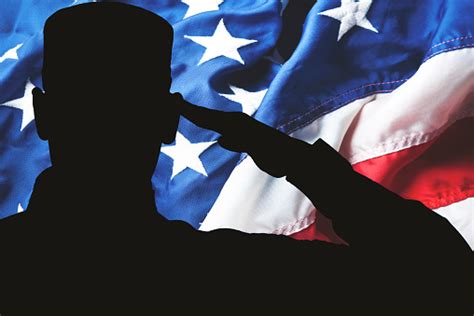 Proud Saluting Male Army Soldier On American Flag Background Stock