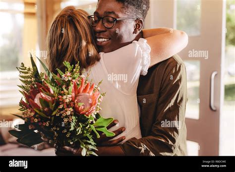 Young African Man Hugging His Girlfriend Standing In Cafe Young Guy Expressing His Love For His