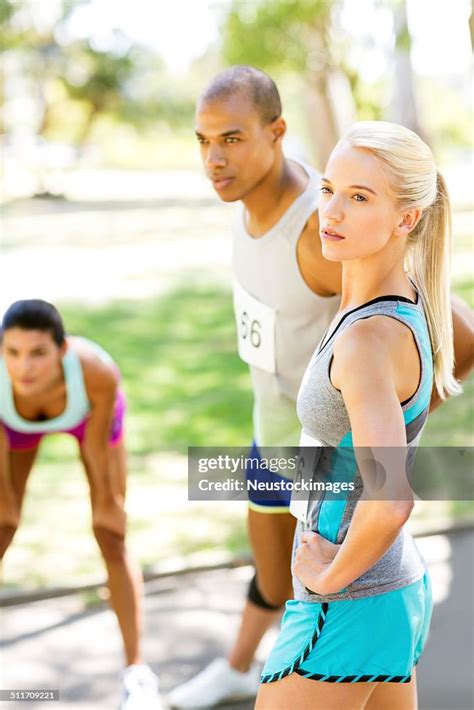 Male And Female Marathon Runners Warming Up High Res Stock Photo