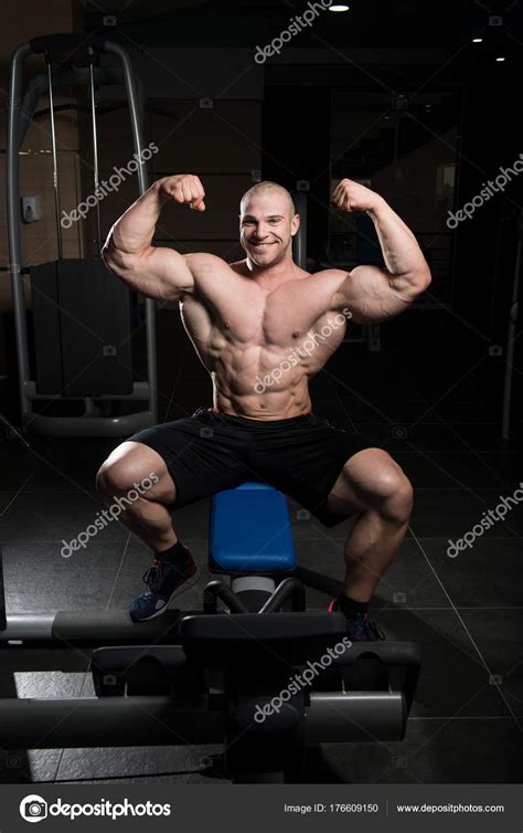Biceps Pose Of A Young Man In Gym Stock Photo By ©ibrak 176609150