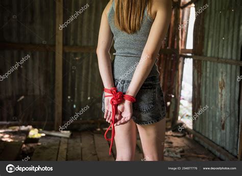 Hostage Girl Hands Tied By Red Rope Stock Photo By Blanscape 294877776