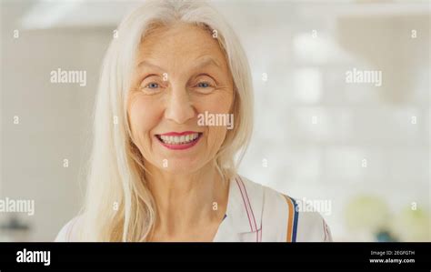 authentic beauty portrait shot of senior female pensioner in a bright room at home beautiful