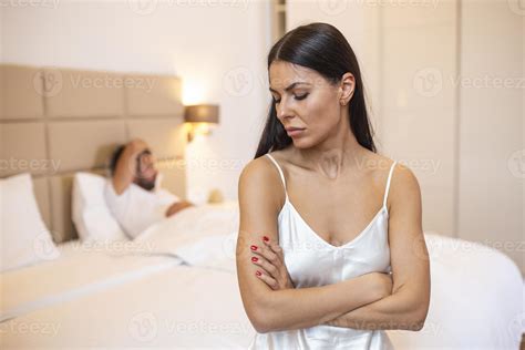 Young Couple Lying In Bed Under Blanket In Bedroom At Home Man