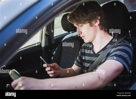 Teenage Boy And New Driver Behind Wheel Of His Car Stock Photo Alamy