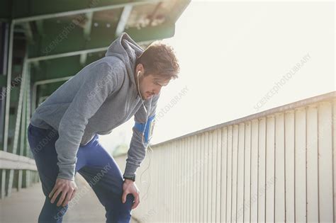 Tired Male Runner Resting Hands On Knees Stock Image F028 3774 Science Photo Library