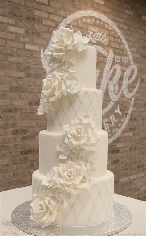4 tier fondant iced wedding cake with double cascade sugar flowers