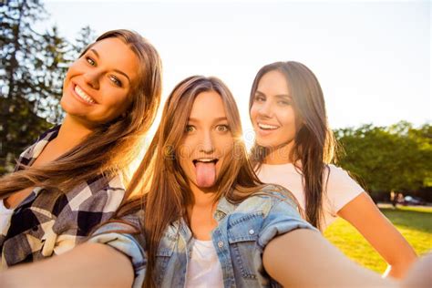 Three Happy Girls Having Fun And Making Comic Selfie With Tongue Stock