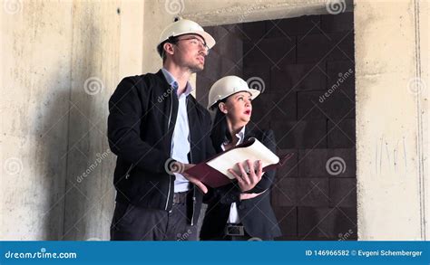 Two Architects A Man And A Woman In Construction In White Helmets Stock Footage Video Of