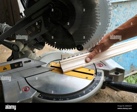 Marking And Cutting Wooden Planks On A Miter Saw An Angle Saw In A