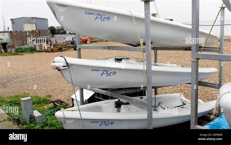 Three Laser Picos Small Sailing Boats Stacked Near The Seafront Stock