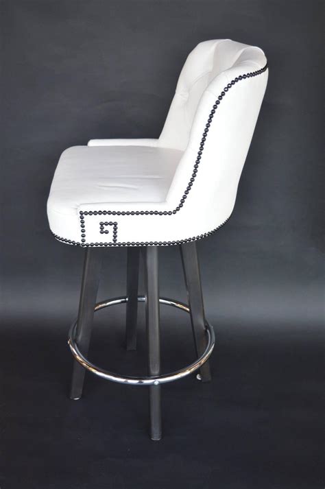 Each stool swivels and adjusts up and down. Set of Three White Leather Bar Stools at 1stdibs