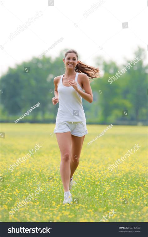 Cute Young Caucasian Woman Running Outdoorsconcept Of