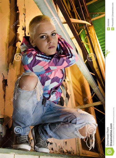 Modern Young Girl Short Blonde Hair Standing On Ledge
