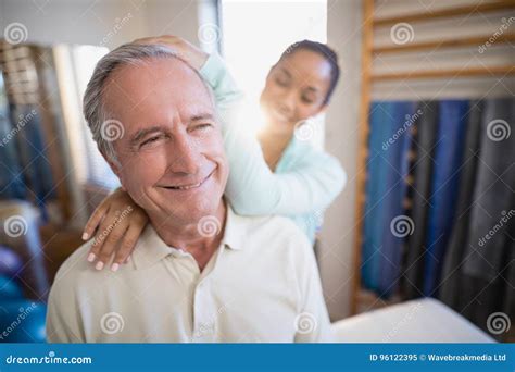 Smiling Senior Male Patient Receiving Neck Massage From Female Therapist Stock Image Image Of