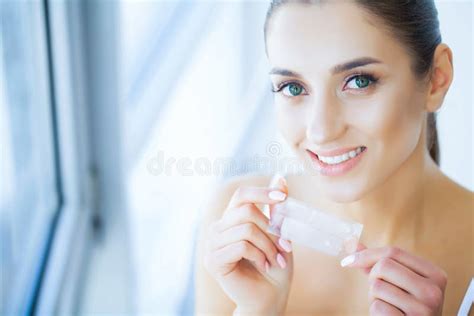 Health And Beauty Beautiful Young Girl With White Teeth Holding Stock