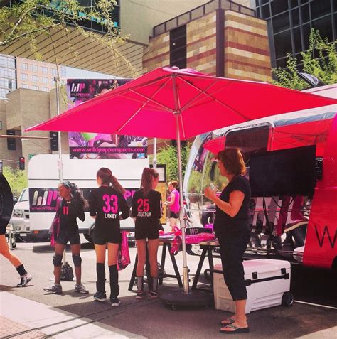 Fans In Pink And Black Checking Out The Wild Pepper Line And Big Pinky Patio Umbrella