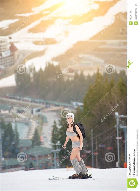 Beautiful Naked Girl Standing On The Snowy Slope Of The Mountain