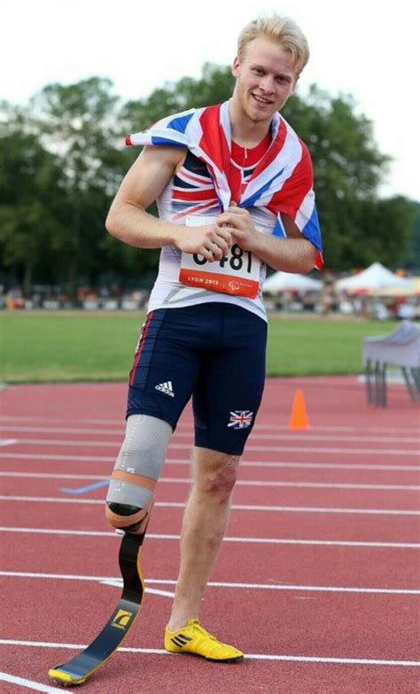 A Man With Knee Braces Running On A Track