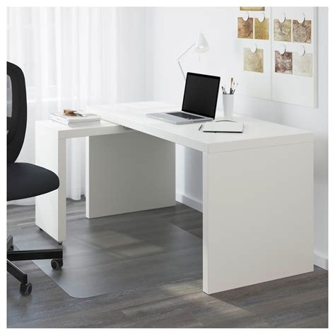 A White Desk With A Laptop On It