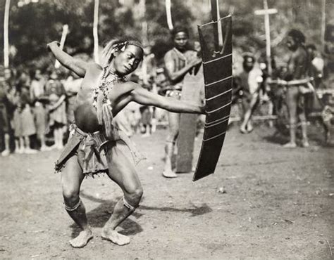 657261 An Ilongot Tribesman Performs A Warrior Dance With Knife And
