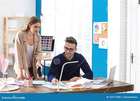 Professional Interior Designer With Colleague In Office Stock Photo