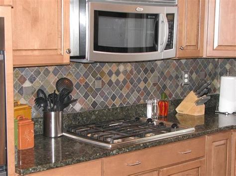 I went back and forth a bit because i love all white kitchens but ultimately the contrast with the dark backsplash tile against the white cabinets won out. Ceramictec - Multi-Color Tumbled Slate Kitchen Backsplash