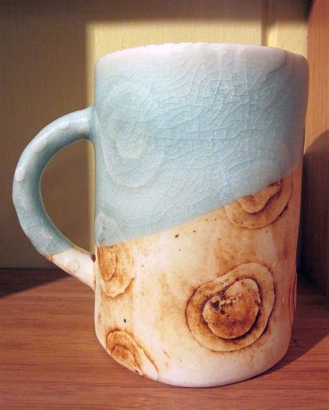 A Ceramic Mug With Two Different Designs On The Outside And Inside