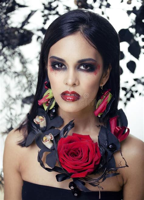 Pretty Brunette Woman With Rose Jewelry Black And Red Bright Make Up A Vampire Closeup Red