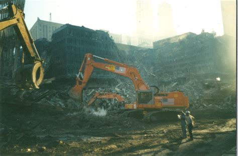 Cranes Sifting Through Debris With Destroyed Wtc 5 And 6 In The Back
