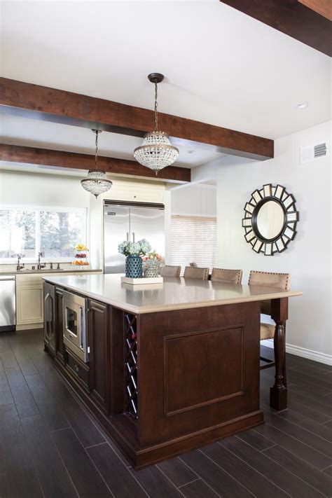 Elegant Kitchen With Exposed Beams Spacious Island And Chandeliers Hgtv