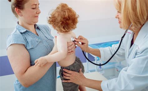 Friendly Doctor Pediatrician With Patient Child At Clinic Stock Image