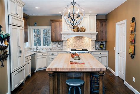 This rustic kitchen features golden brown shaker cabinetry paired with a mint green wall hue and neutral tile backsplash. White Painted Maple & Rustic Hickory Kitchen - Randall ...