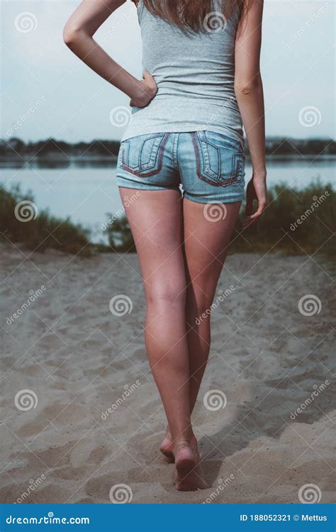 Sporty Girl Spending Time By A Lake Back View Rear View Of Young Woman