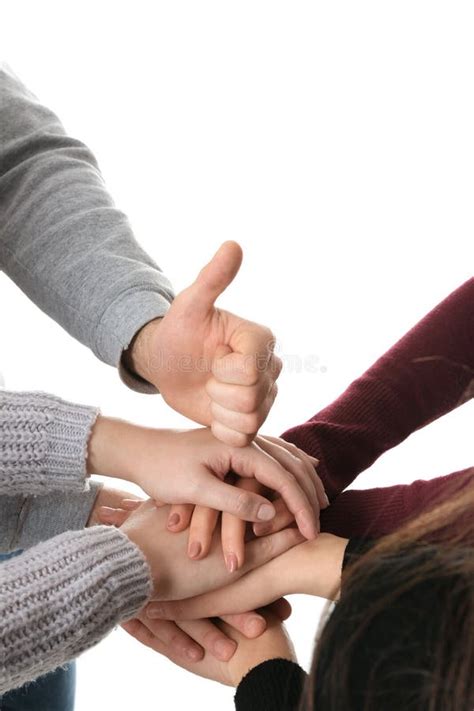 Young People Putting Their Hands Together On White Closeup Stock Photo