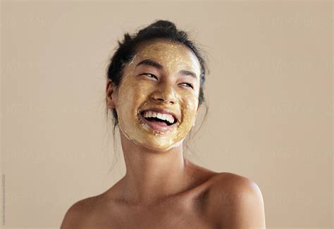 Happy Woman With Golden Facial Mask Del Colaborador De Stocksy