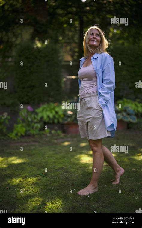 Mature Woman With Barefoot Walking In Garden Stock Photo Alamy