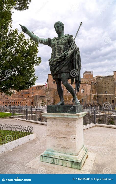 Statue Of Julius Caesar And The Ancient Forum On The Background