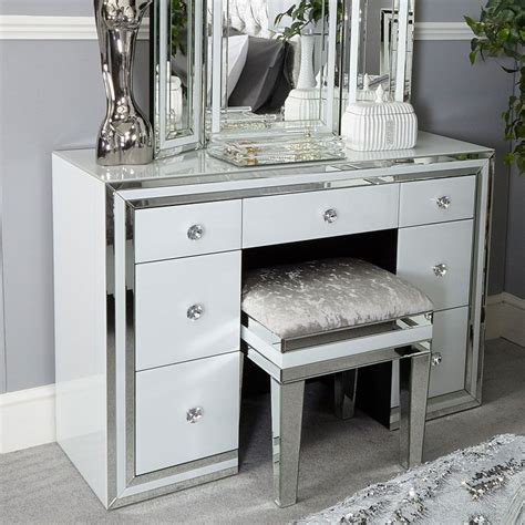 Choose between a modern dressing table with hard and clean edges and an antique looking dressing table with smother, rounder edges. Madison White Glass 7 Drawer Mirrored Dressing Table (With images) | Mirrored bedroom furniture ...