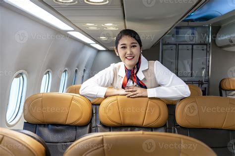 Asian Flight Attendant Posing With Smile Inside Aircraft For Welcoming