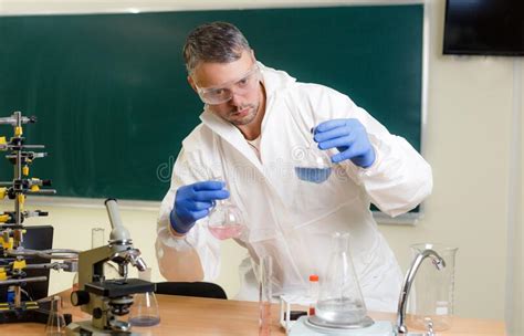 A Male Scientist In The Lab Is Conducting Research Mixing Various