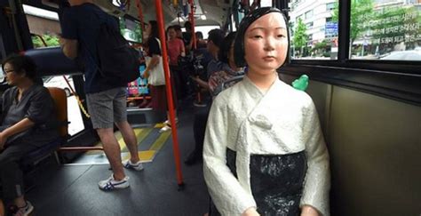 south korean buses carry statues of comfort women