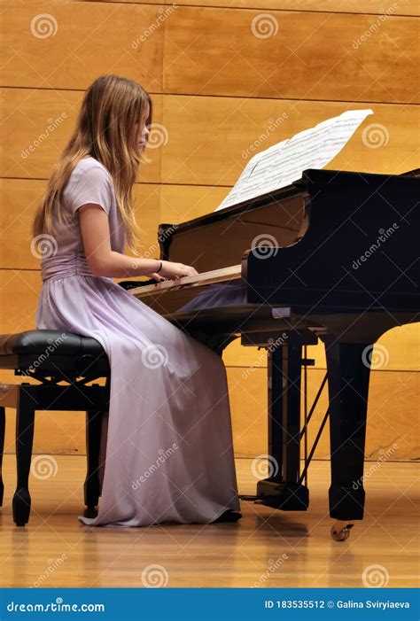 Piano Music Concert A Young Girl In A Lilac Dress Plays The Piano On