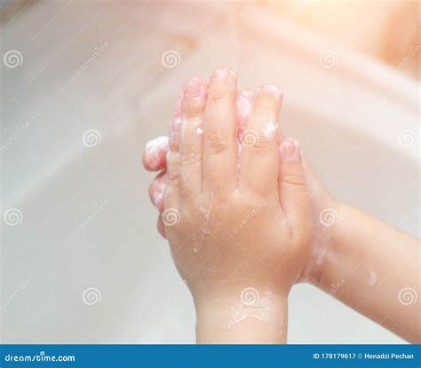 A Child Washes His Hands With Soap In The Bathroom The Concept Of