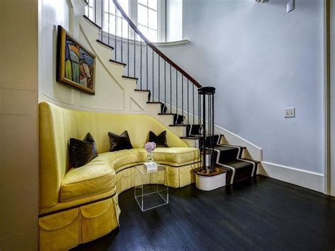There tend to be a lot of stair designs to choose from. Yellow Sofa On Curved Staircase Wall - Transitional - Entrance/foyer