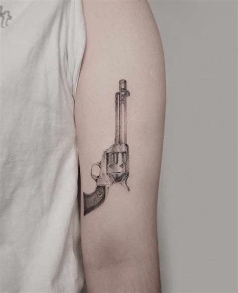 25 Of The Best Gun Tattoos Tattoo Insider Dainty Tattoos Leg Tattoos